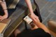 A woman sitting at a table with a cell phone in her hand.