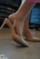 A close up of a woman's legs wearing high heels.