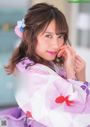 A woman in a kimono with a flower in her hair.