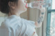 A woman drinking water from a plastic bottle.